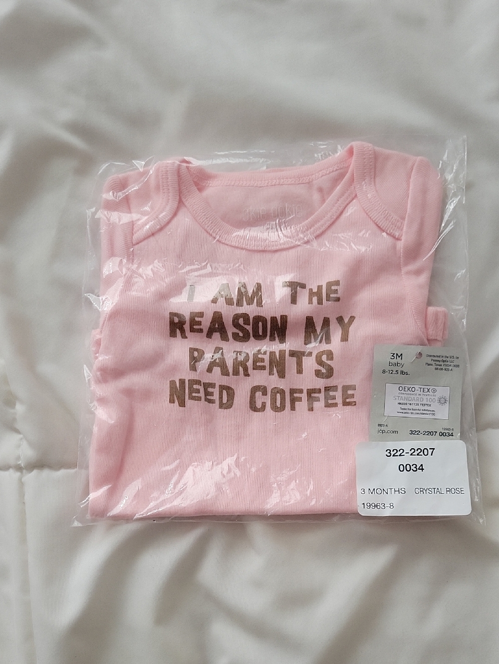 Pink Baby Onesie with 'I Am The Reason My Parents Need Coffee'
